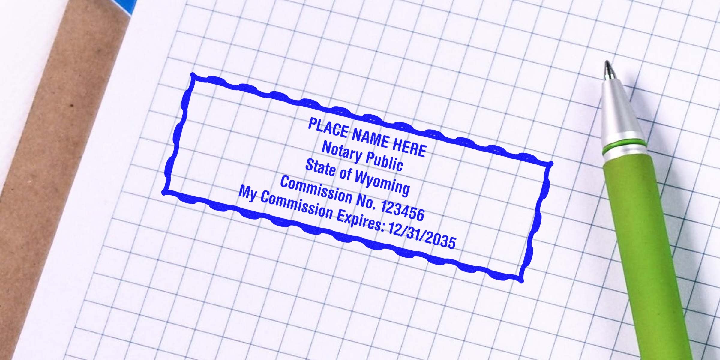 Blue notary public stamp on graph paper reading "Notary Public, State of Wyoming, Commission No. 123456, Expires 12/31/2035" beside a green pen — business notary stamp, commission seal, office paperwork image