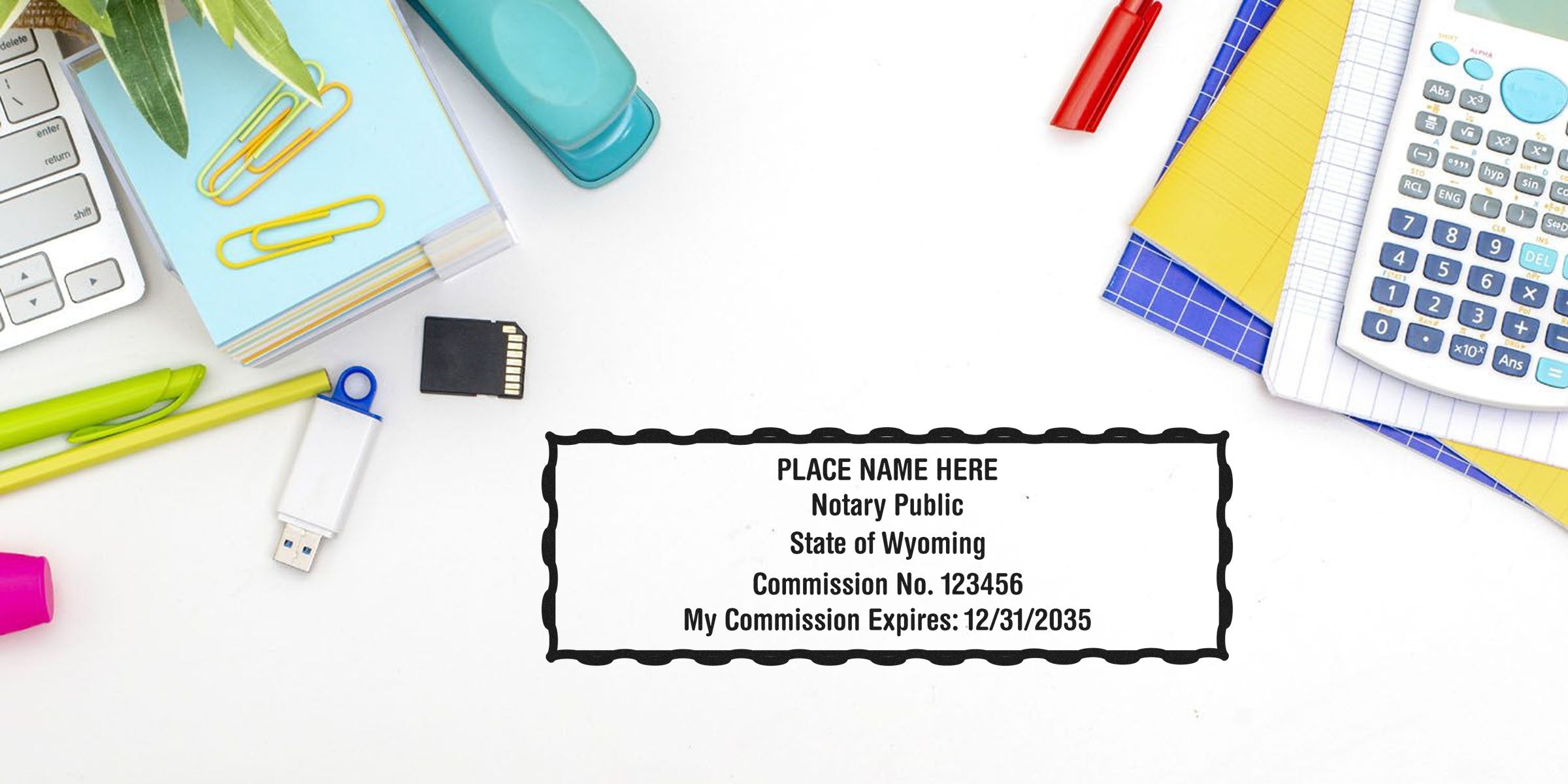 Top-down office desk flat lay with calculator, USB drive, SD card, stapler, pens, highlighters and sticky notes alongside a sample Notary Public stamp reading "Place Name Here, State of Wyoming, Commission No. 123456, My Commission Expires: 12/31/2035."