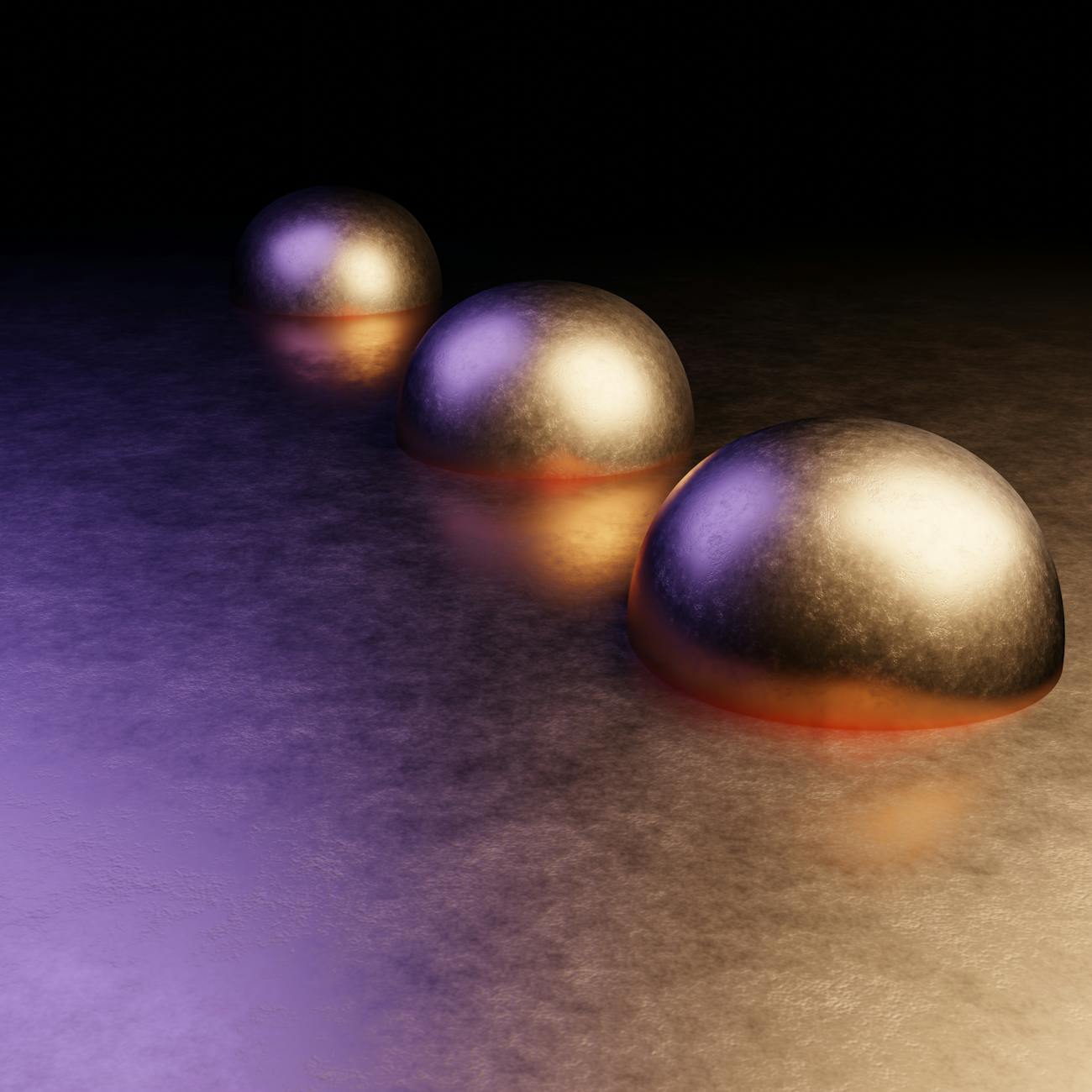Three metallic gold hemispheres aligned diagonally on a textured reflective surface, lit by purple and warm orange highlights against a black background.