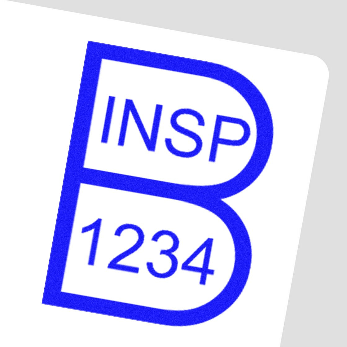 Blue INSP 1234 rubber stamp seal with bold outlined B-shaped design on a white background.