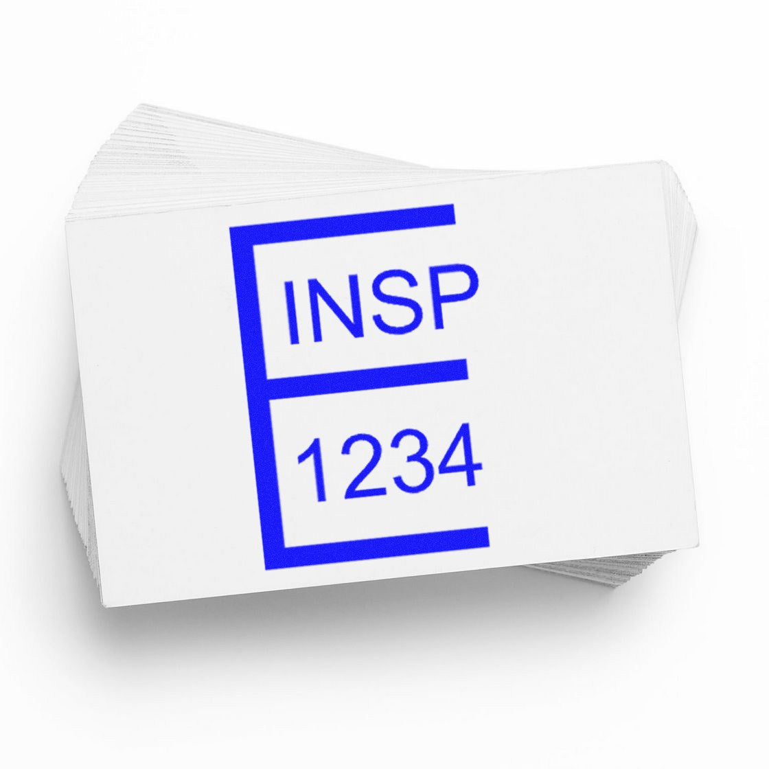 White inspection stamp seal cards with bold blue INSP 1234 imprint on a stacked paper pad.
