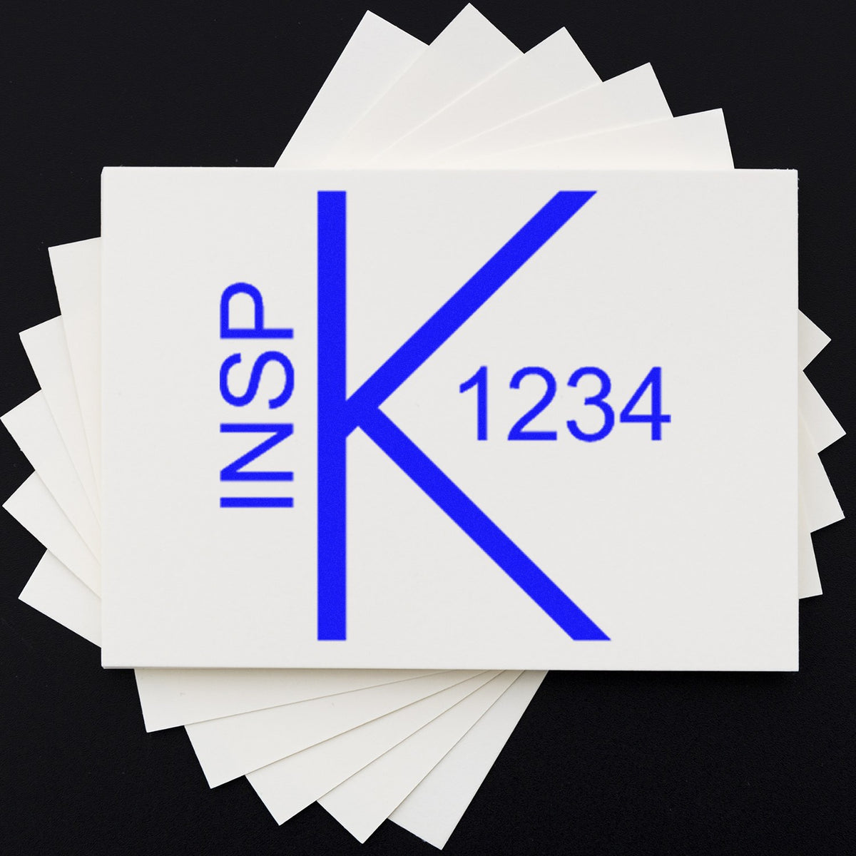 Stacked white stamp and seal cards with blue INSP K 1234 logo on black background.