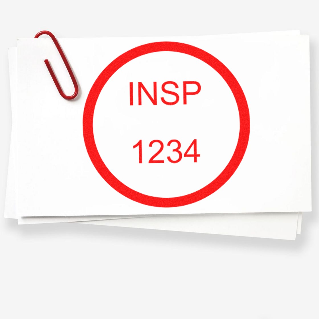Red inspection stamp seal reading INSP 1234 on stacked white papers with a red paperclip.