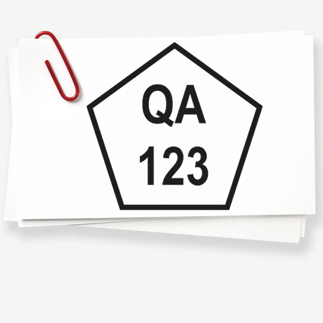 White stamp-and-seal card with black pentagon seal labeled QA 123, clipped with a red paperclip.