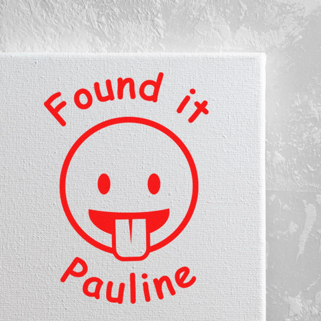 Red stamp seal with playful face and Found it Pauline text on a white textured background.