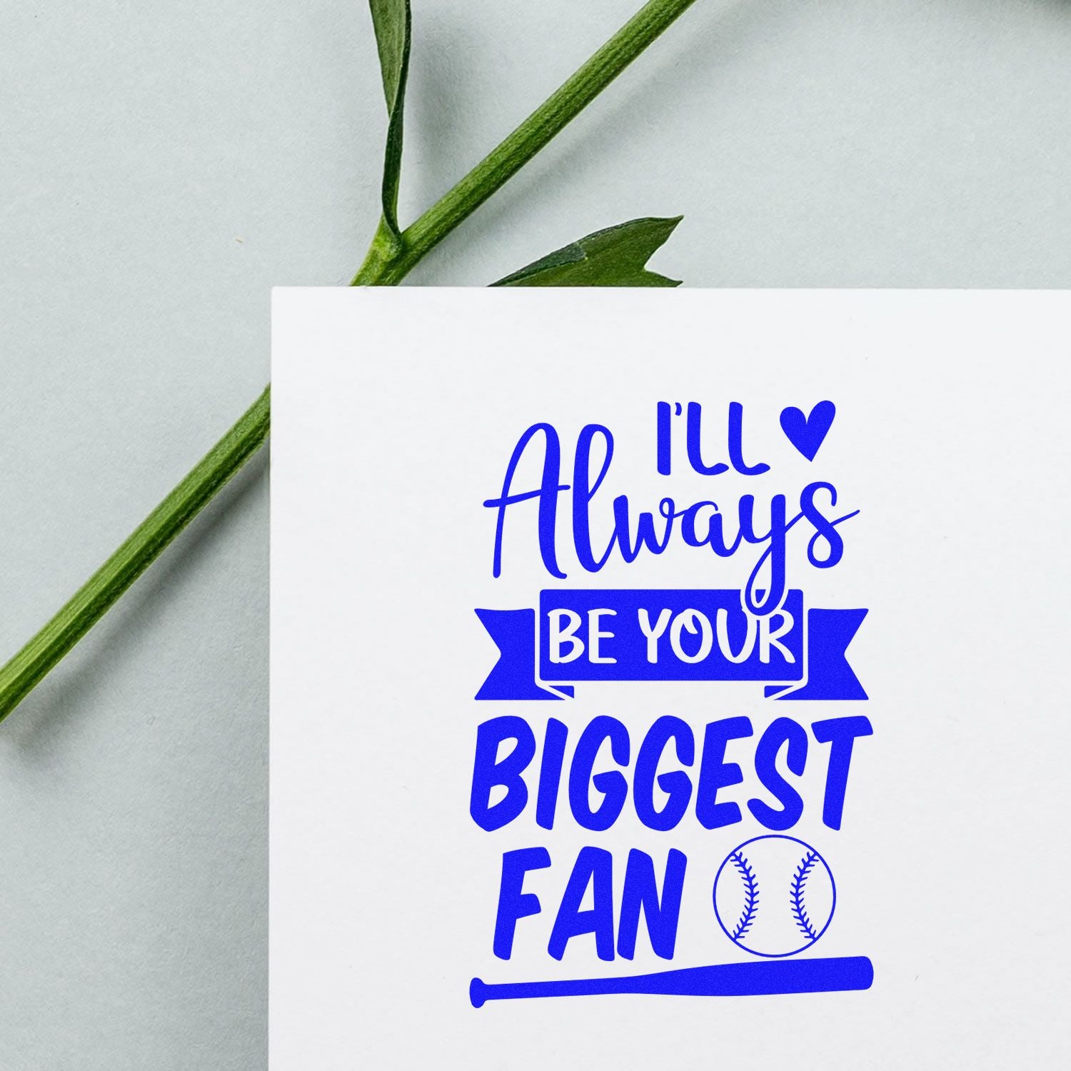 Blue stamp and seal reading Ill Always Be Your Biggest Fan with a baseball icon on a white card