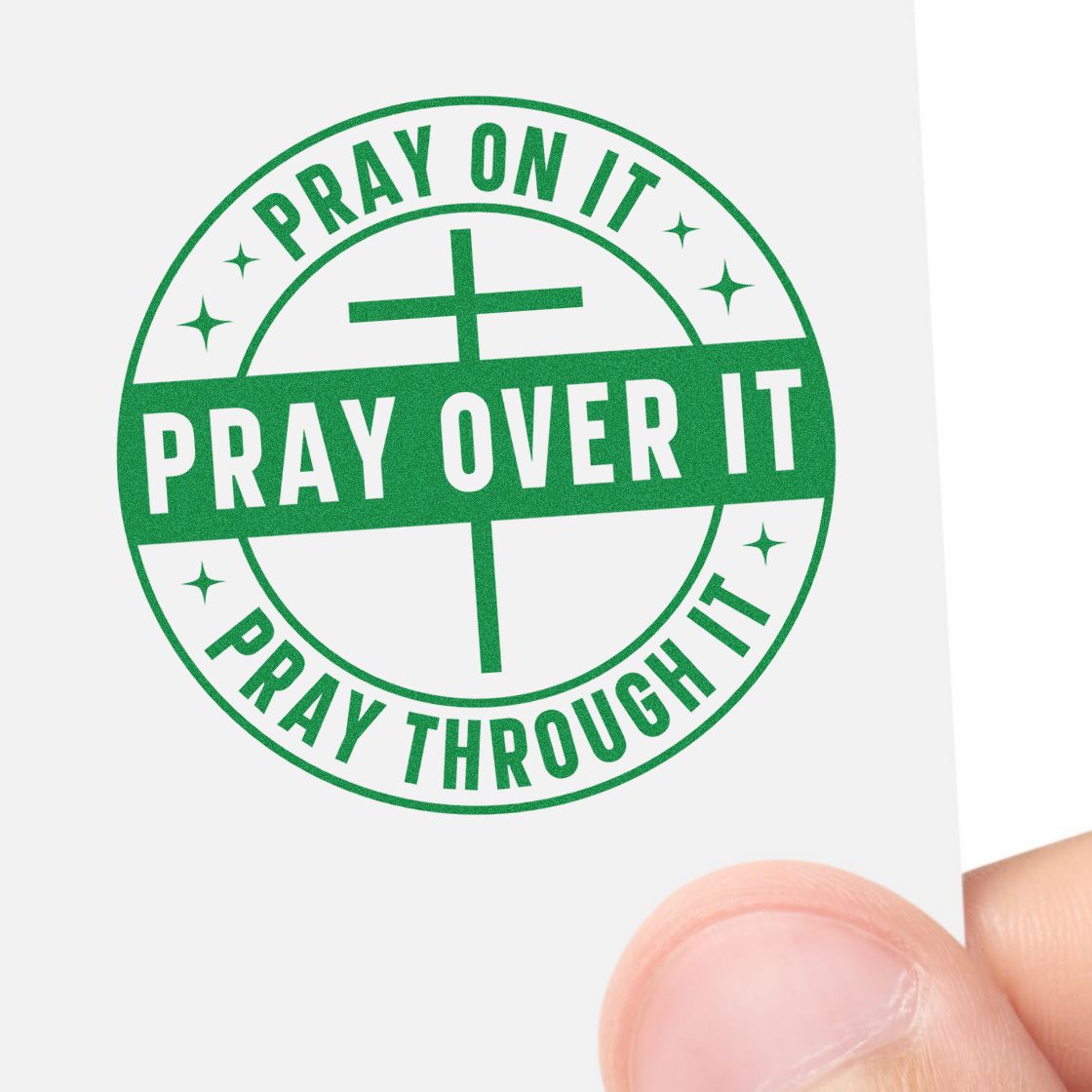 Green circular prayer stamp seal with cross and text, Pray On It, Pray Over It, Pray Through It, on white paper.