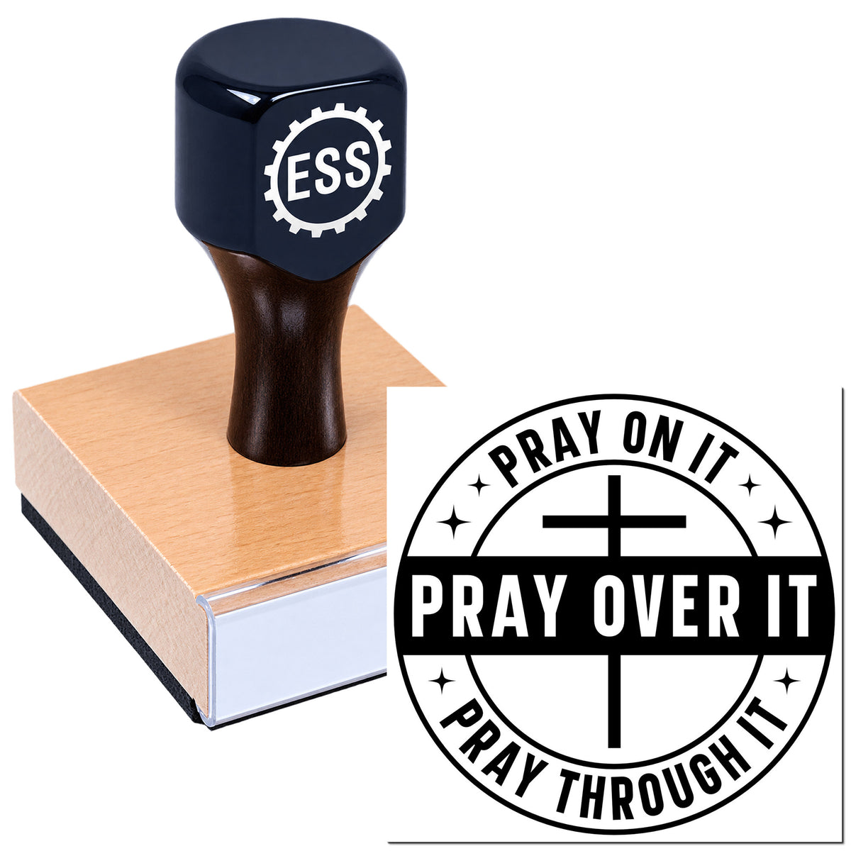 Black rubber stamp on wooden block with PRAY ON IT seal and cross emblem, shown on a white background.