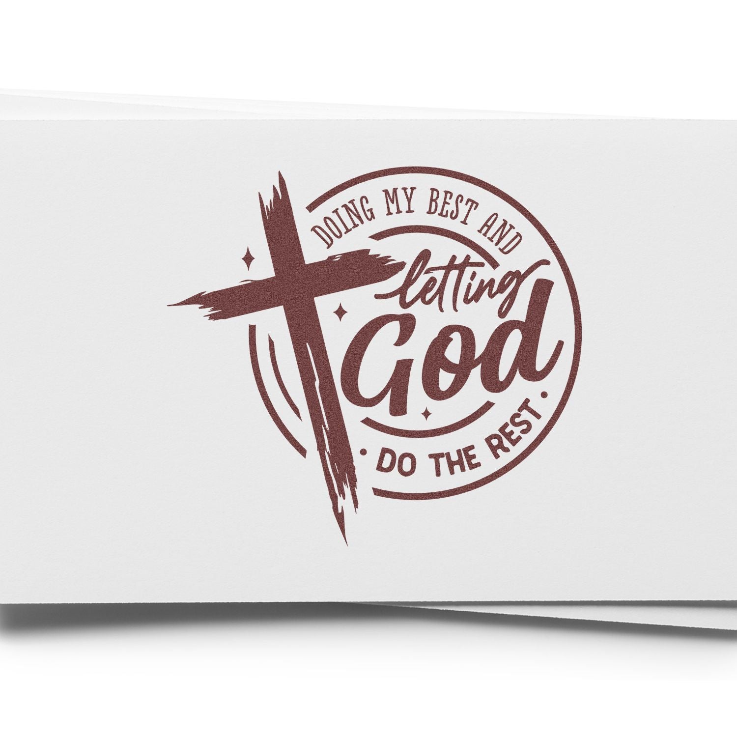 Maroon rubber stamp seal with cross and text Doing my best and letting God do the rest on white paper.
