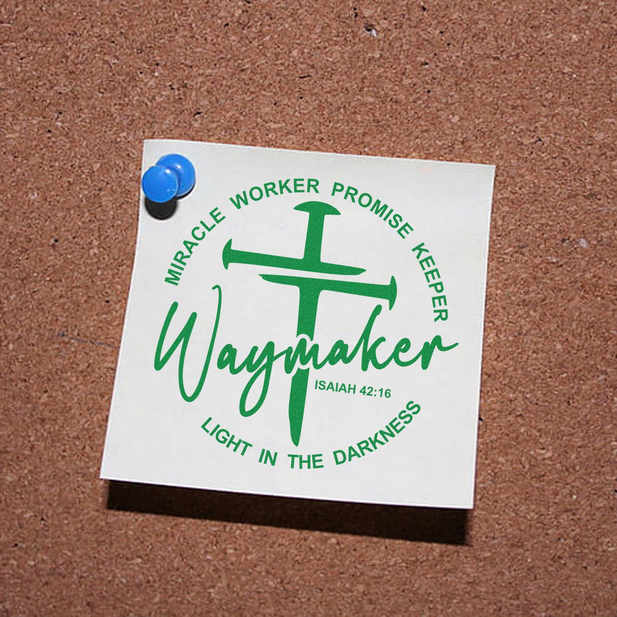 Green Waymaker stamp and seal design with green cross and Bible verse, pinned to corkboard with blue pushpin.