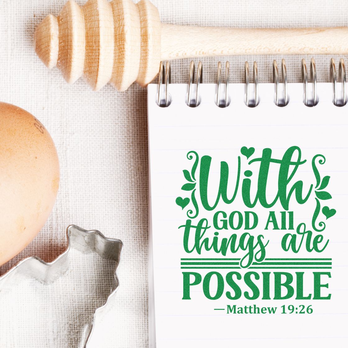 Green With God all things are possible stamp on spiral notebook, with wooden seal stamper and metal cutter on beige linen.