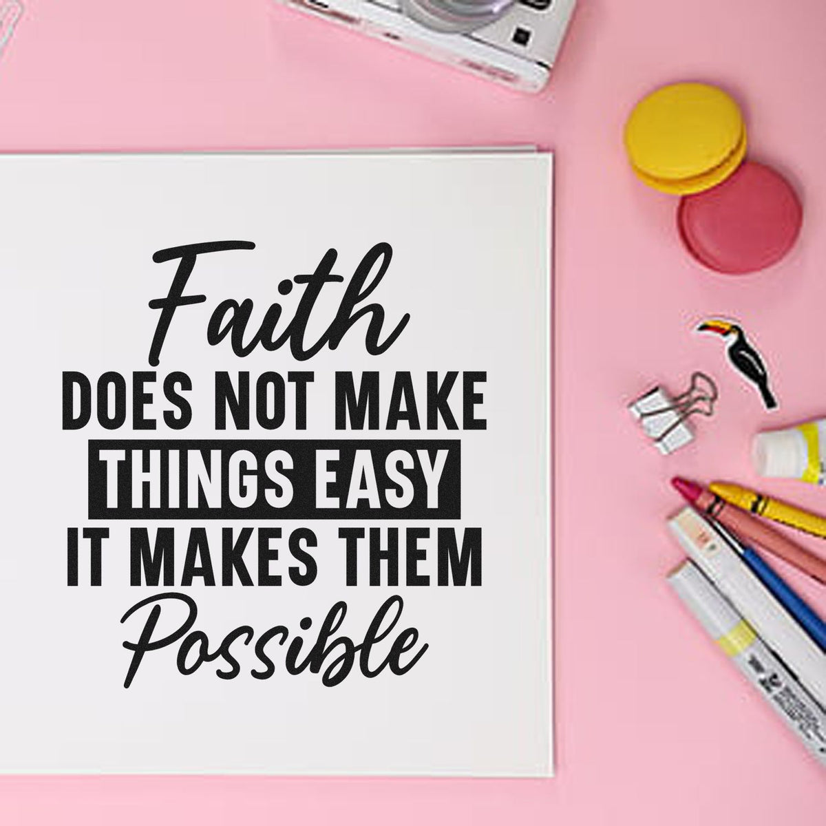 White stamp quote card on pink background with black text, colorful stamp and seal products, markers, and round ink pads.