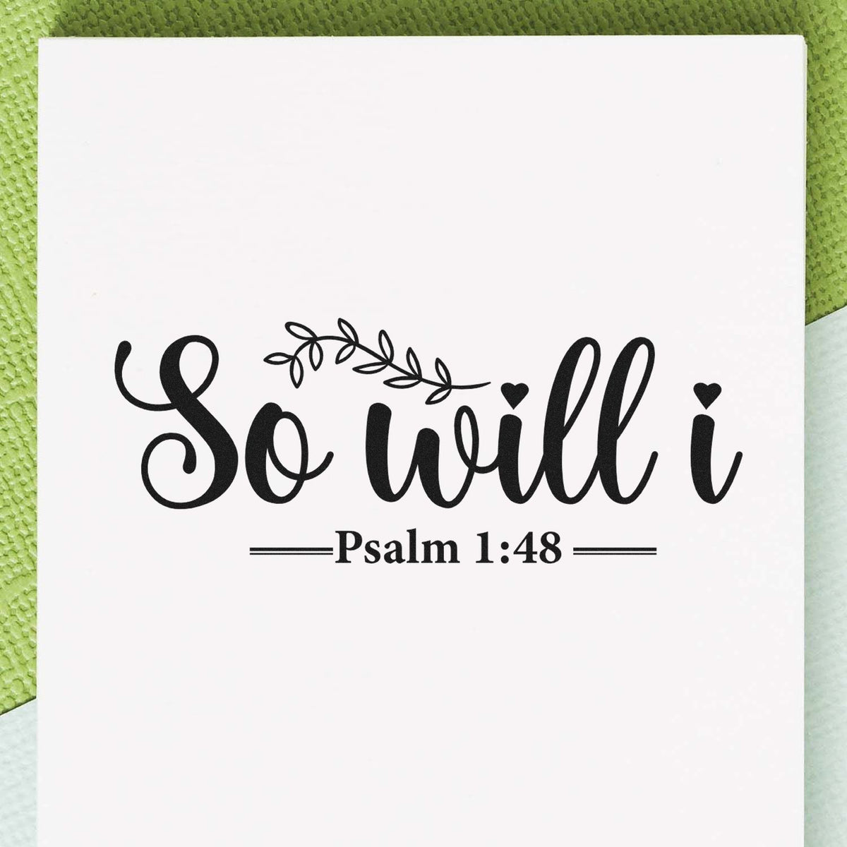 Black script stamp design reading So will I with vine and heart accents, Psalm 1:48, on white card over green background.