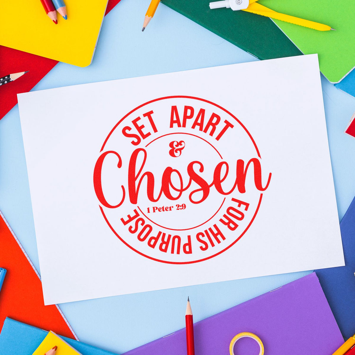 Red circular stamp seal reading Set Apart & Chosen for His Purpose on white paper, surrounded by colorful pencils.