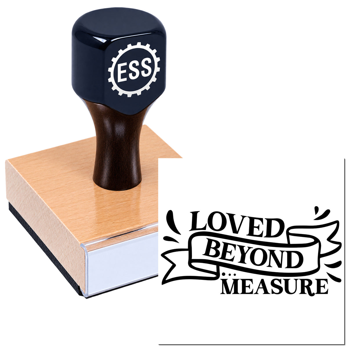 Black rubber stamp with wooden handle on pink block, showing "LOVED BEYOND MEASURE" seal on white background.
