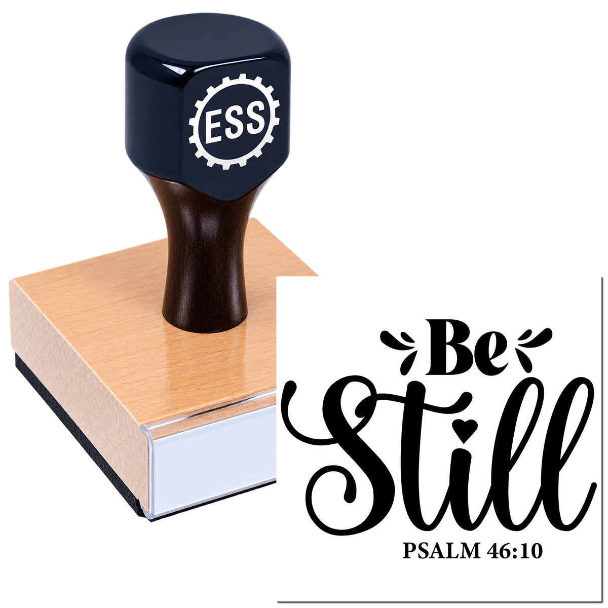 Black custom rubber stamp with ESS logo on a wooden block, beside a white seal design reading "Be Still" in black script.
