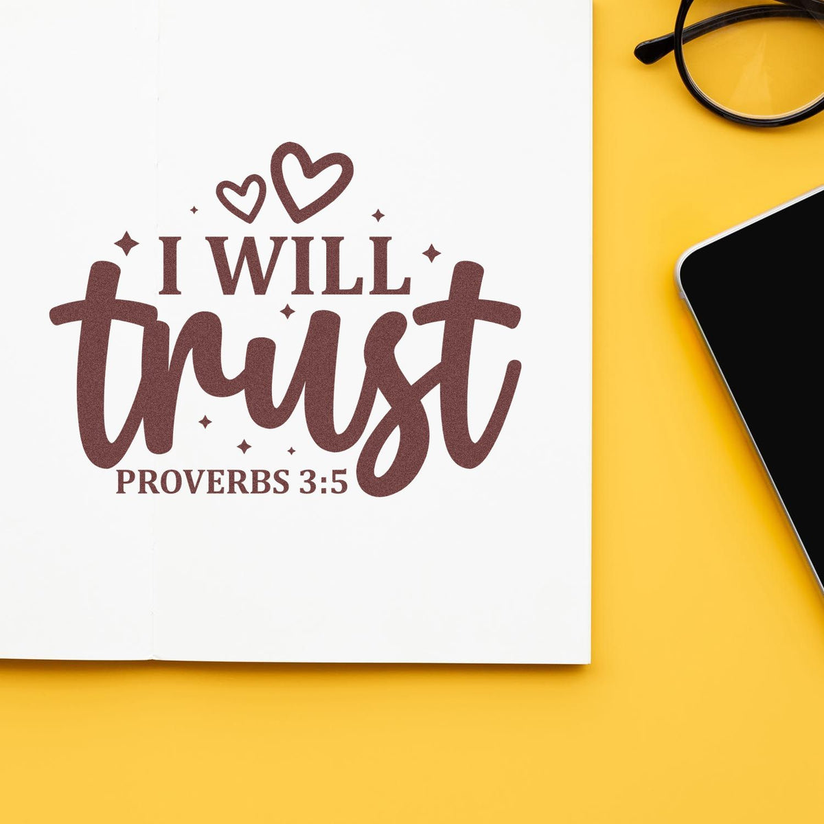 Brown scripture stamp and seal reading I will trust with hearts and Proverbs 3:5 on white paper, yellow background.