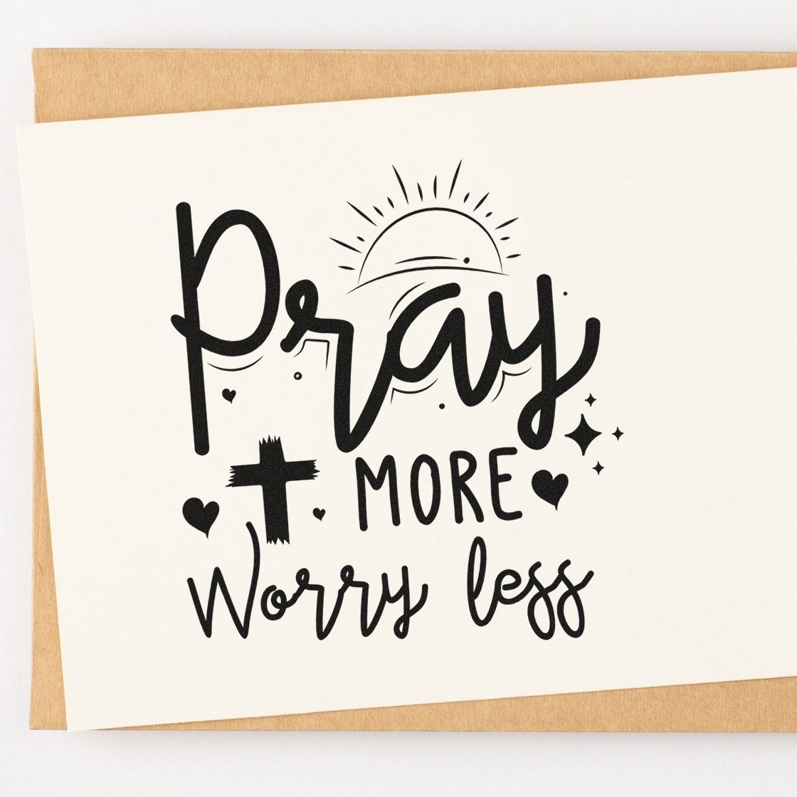 Pray More Worry Less Sunrise With Cross Compact Pre-Inked Stamp – Slim imprint stamped in black ink. A rising sun, cross, hearts, and sparkles accent "Pray more, worry less."