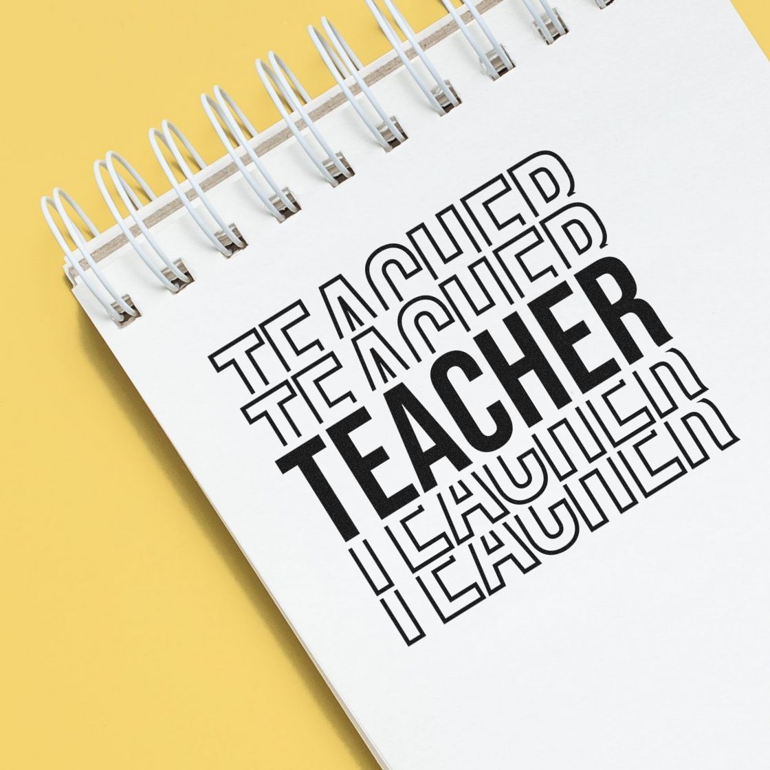 Teacher stamp and seal design on a white spiral notebook, with bold black and outlined text on a yellow background.