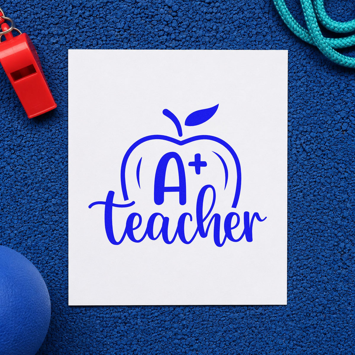 A Plus Teacher Apple craft stamp imprinted in blue ink on paper, a design suited to honor roll labels.