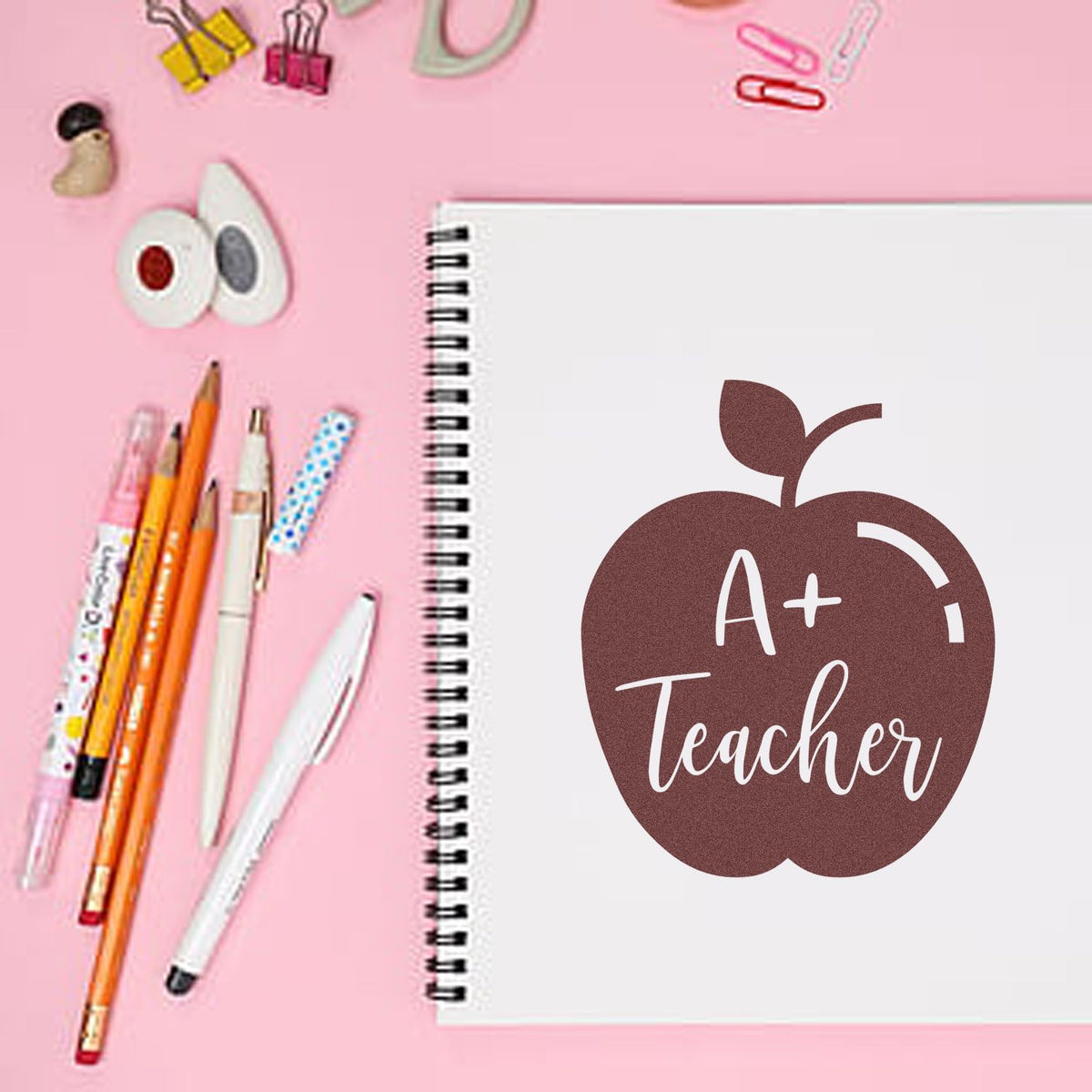A Plus Teacher Solid Apple rubber stamp shown in brown ink, stamped for projects such as top grade tags.