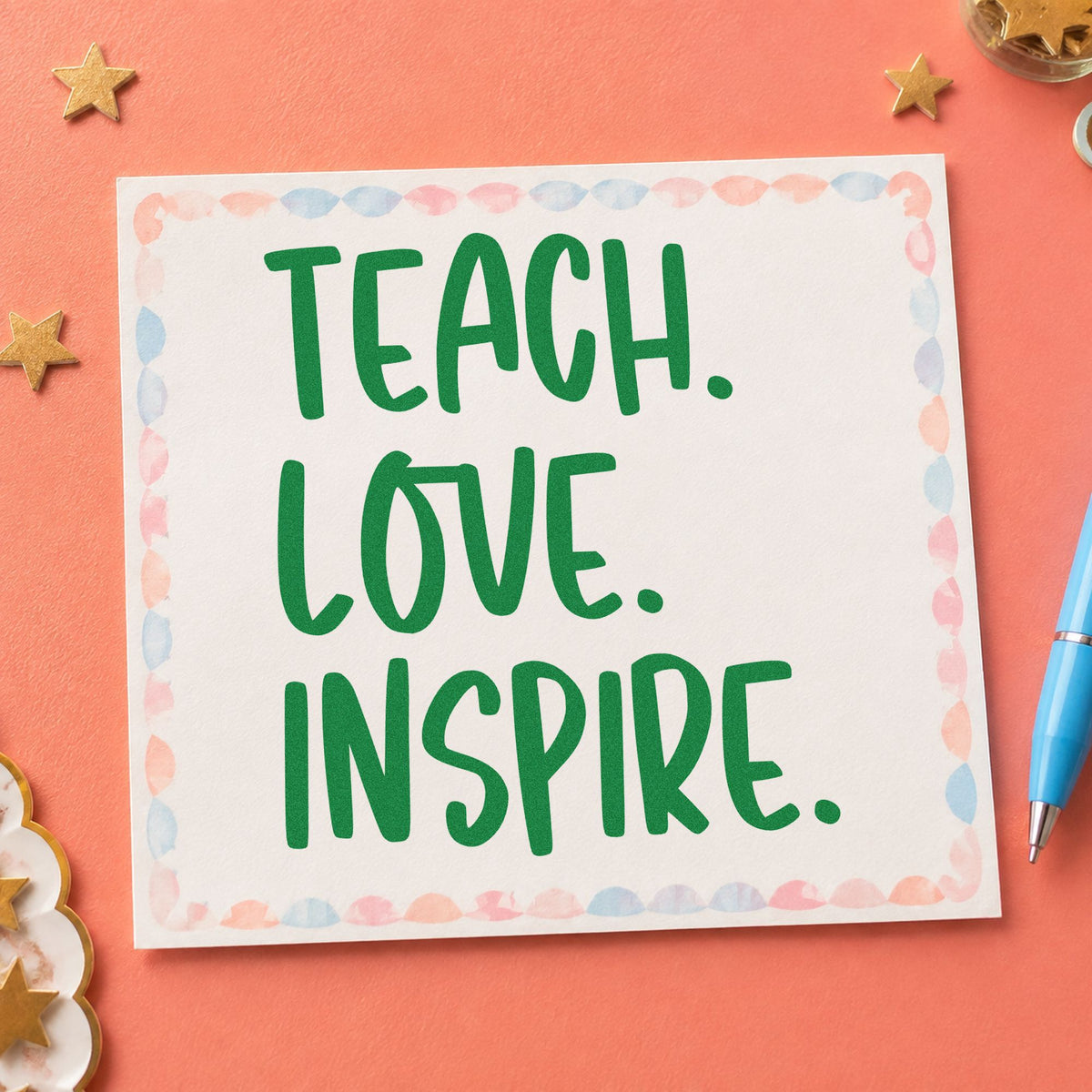 Teach Love Inspire Capitals craft stamp imprint in green ink on a handmade project, one idea being zine page spreads.