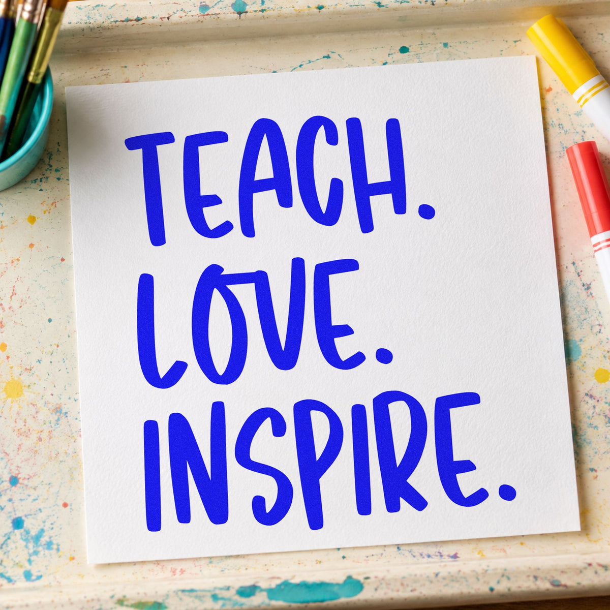 Teach Love Inspire Capitals craft stamp in blue ink on cardstock, an easy option for calico bag panels.