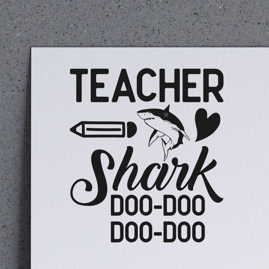 Black teacher shark stamp and seal design on white paper with pencil, heart, and Doo-Doo text