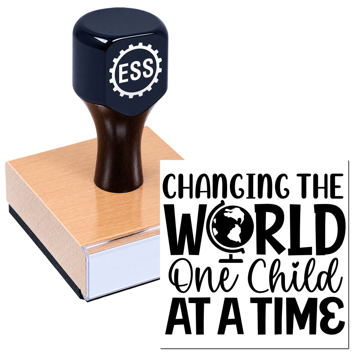 Black ESS rubber stamp seal on a wooden block, with gear logo and "Changing the World One Child at a Time" slogan.
