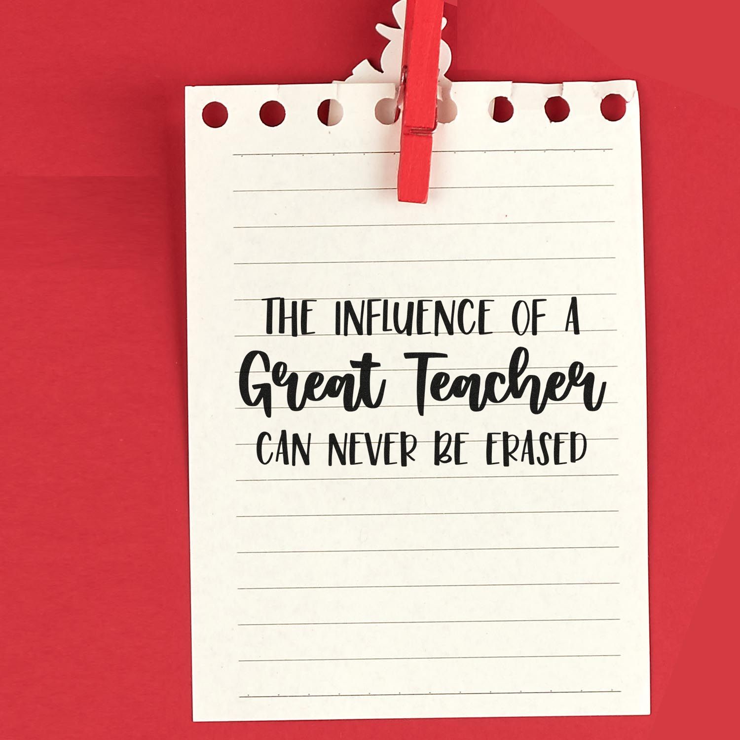 Red stamp-and-seal teacher note card clipped with a red clothespin, featuring a black quote on white lined paper.