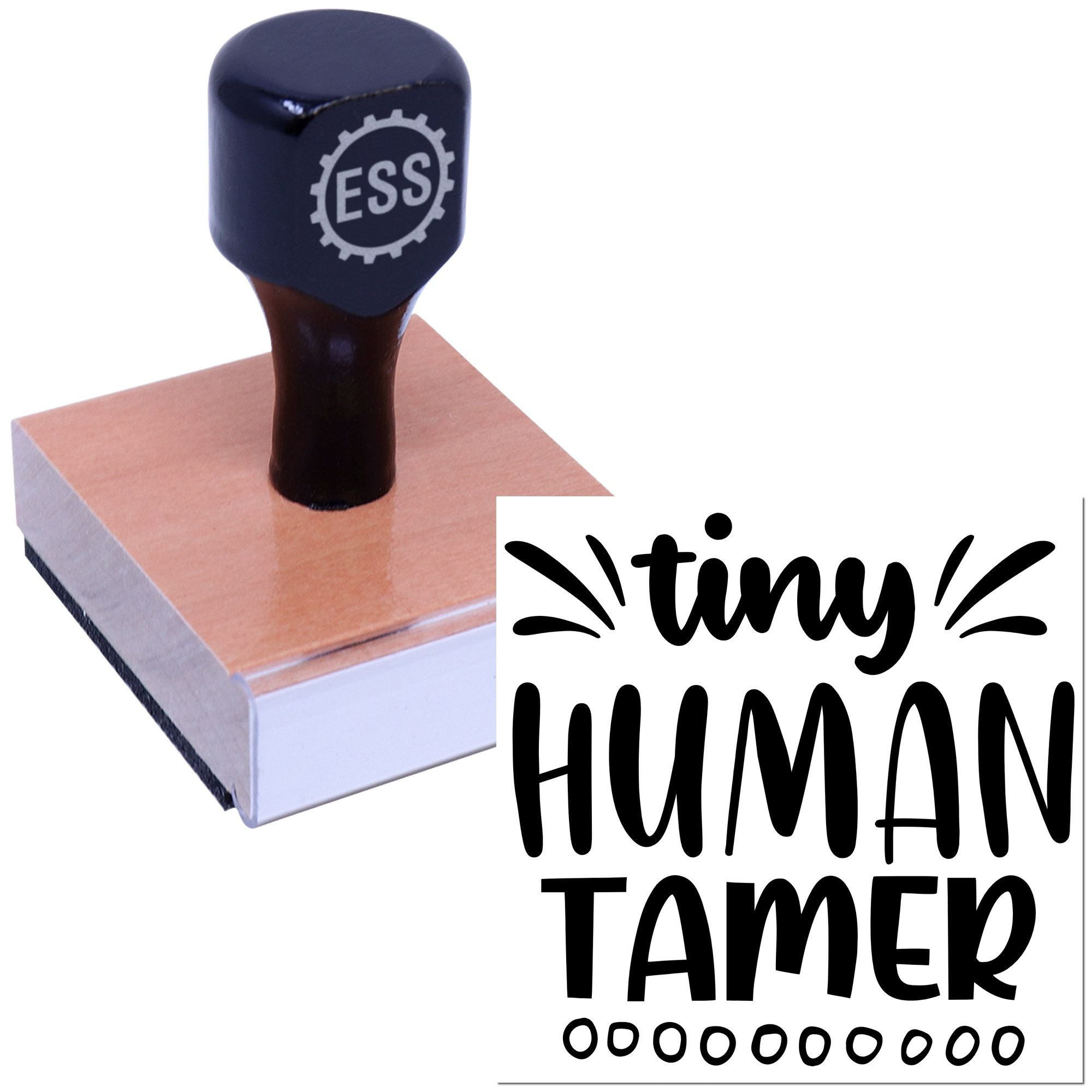 Dark navy ESS rubber stamp on a wooden block beside a black tiny HUMAN TAMER seal design.