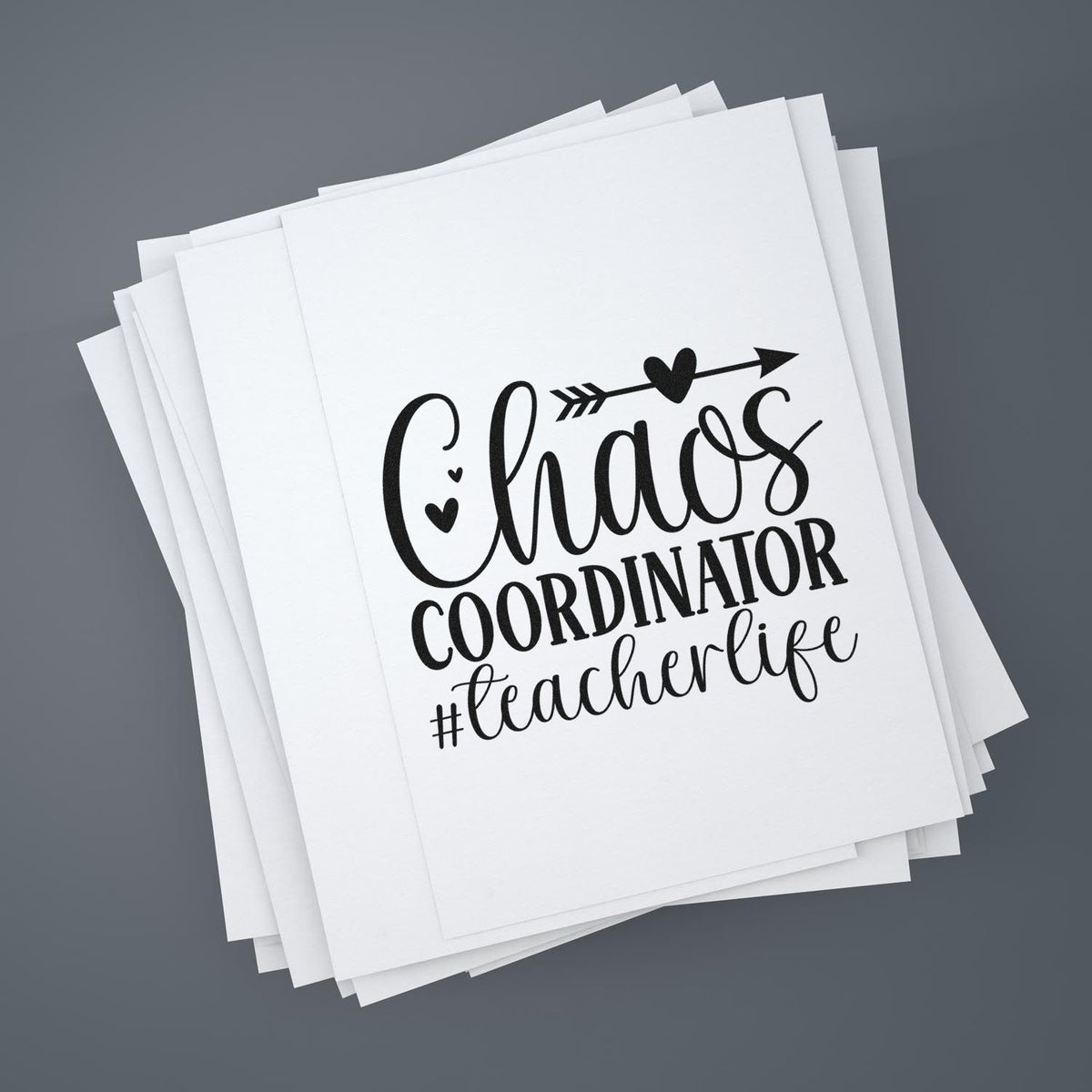 Black custom stamp and seal design on stacked white cards reading Chaos coordinator #teacherlife with heart and arrow.
