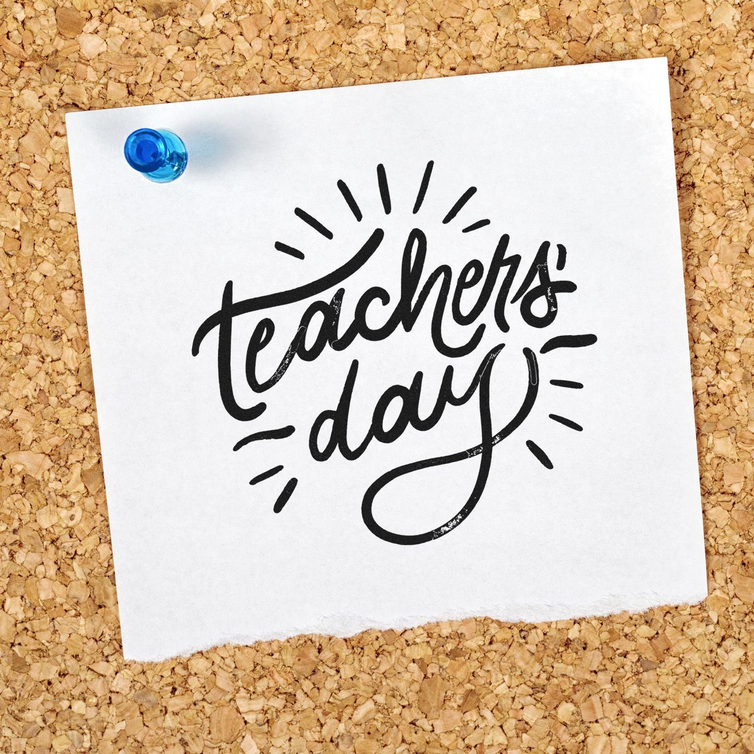 Black Teacher Day stamp design on white paper, pinned with a blue pushpin on corkboard.