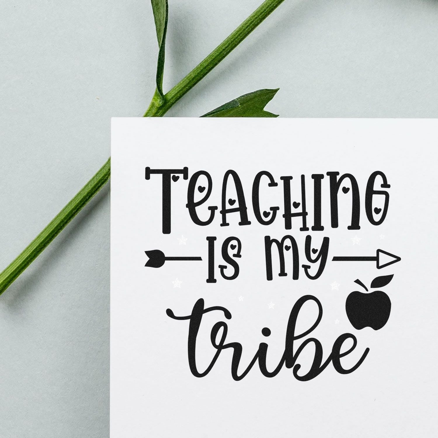 Black Teaching Is My Tribe stamp seal with apple and arrow on white card, pale gray background and green stem