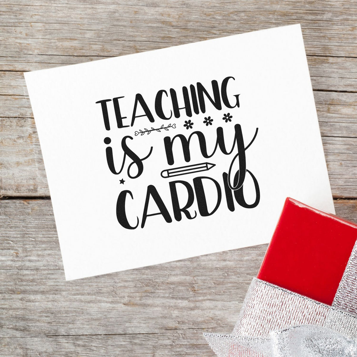 Black Teaching is my cardio rubber stamp on white card, beside a red self-inking stamp on rustic wood.