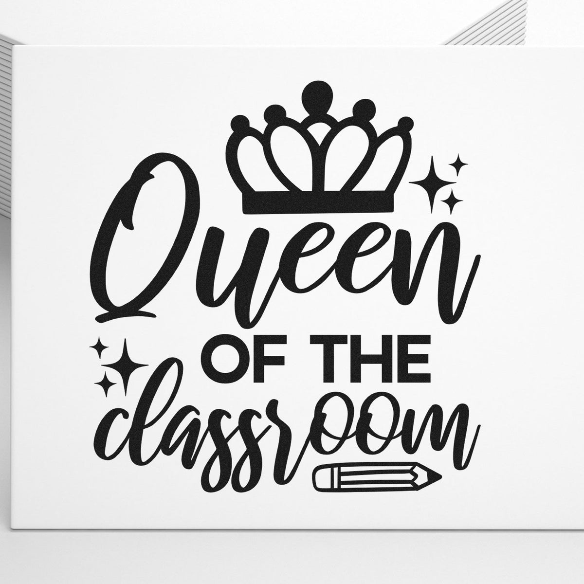Queen Of The Classroom Crown Pencil Compact Pre-Inked Stamp – Slim imprint stamped in black ink. “Queen of the Classroom” is topped with a crown and accented with sparkles and a pencil.