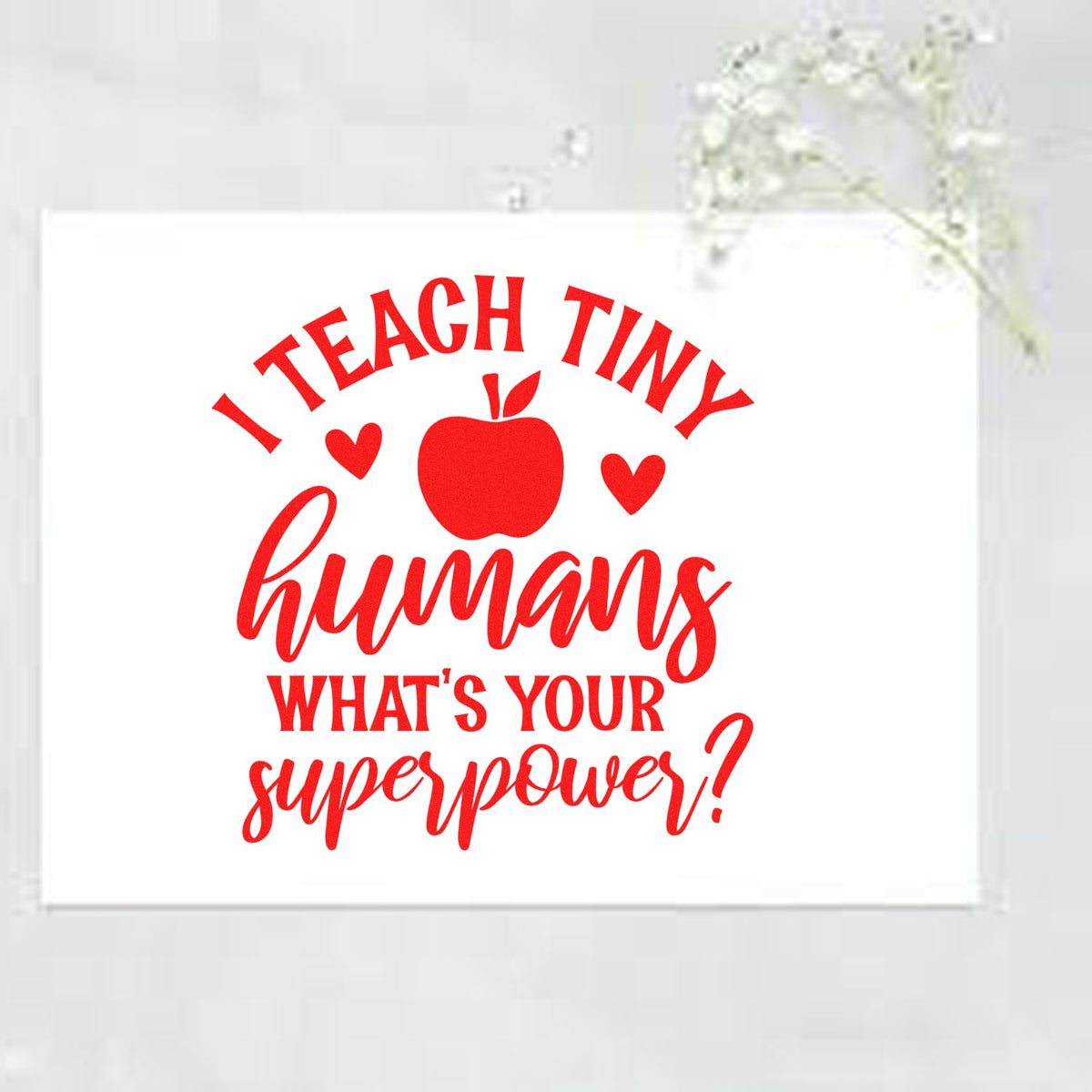 Red teacher stamp and seal design with apple and hearts on white, reading I teach tiny humanswhats your superpower?