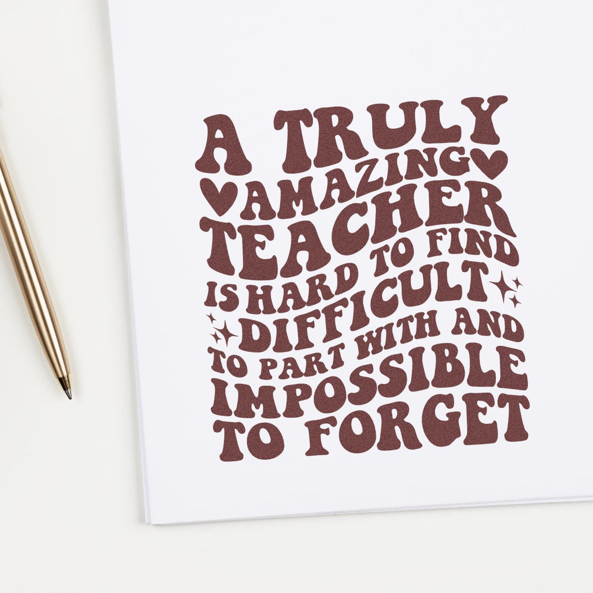 Brown stamped quote on white paper with gold pen: A truly amazing teacher... stamp and seal design.