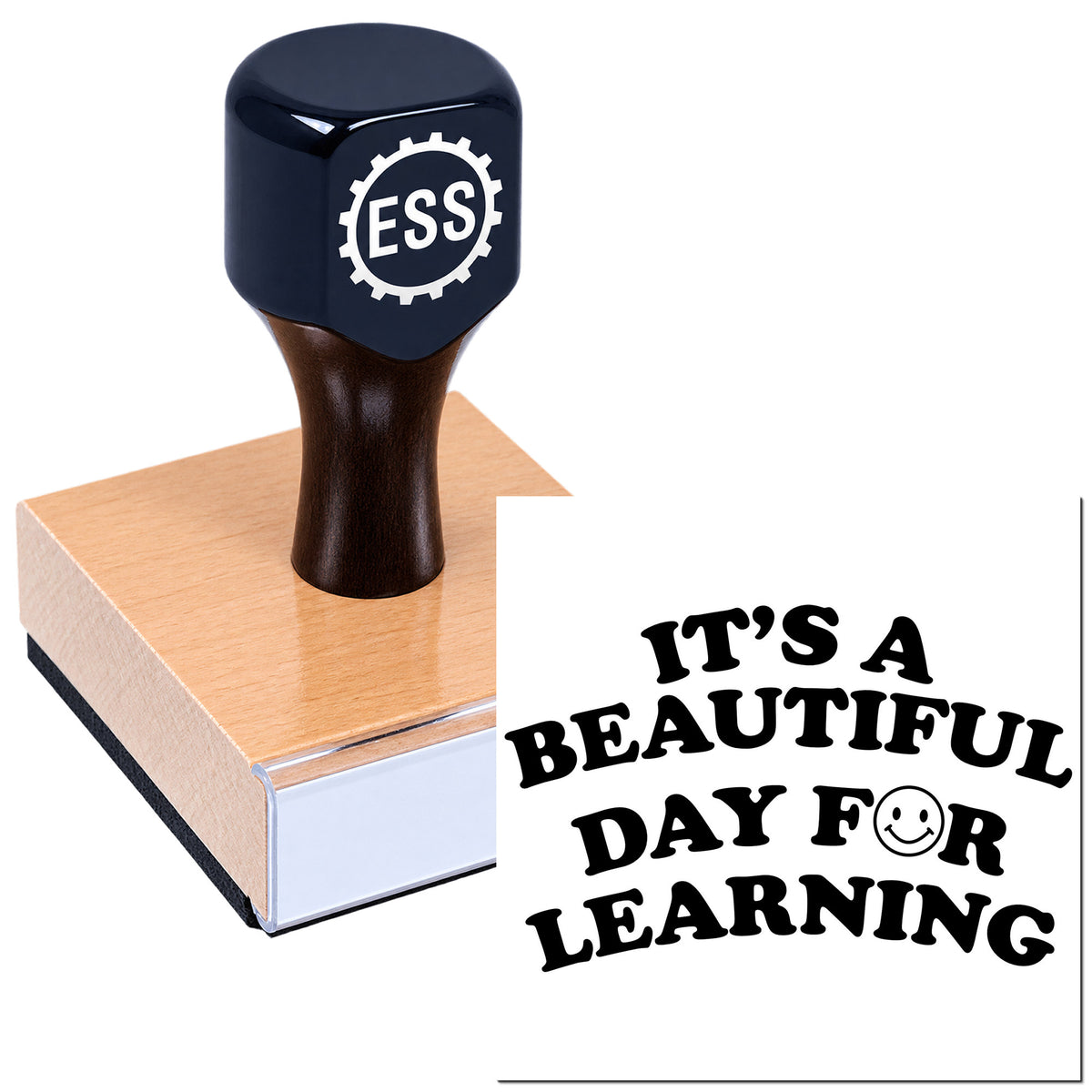 Black ESS rubber stamp and seal on a wooden block with bold black slogan, "It's a beautiful day for learning."