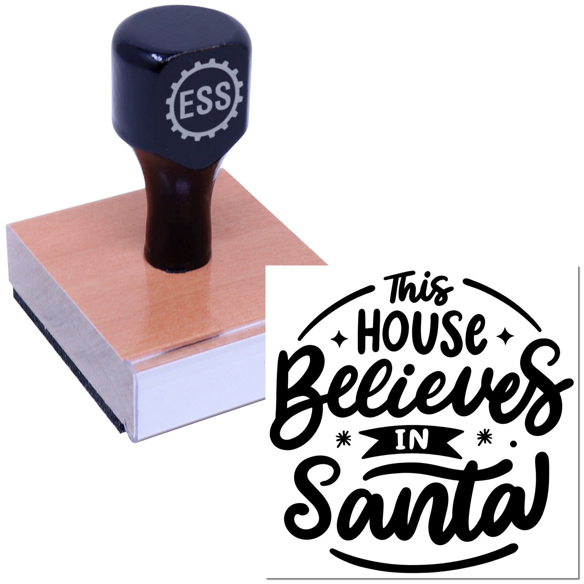 Black ESS stamp on a pink block with a sample seal reading This House Believes in Santa in bold black script.