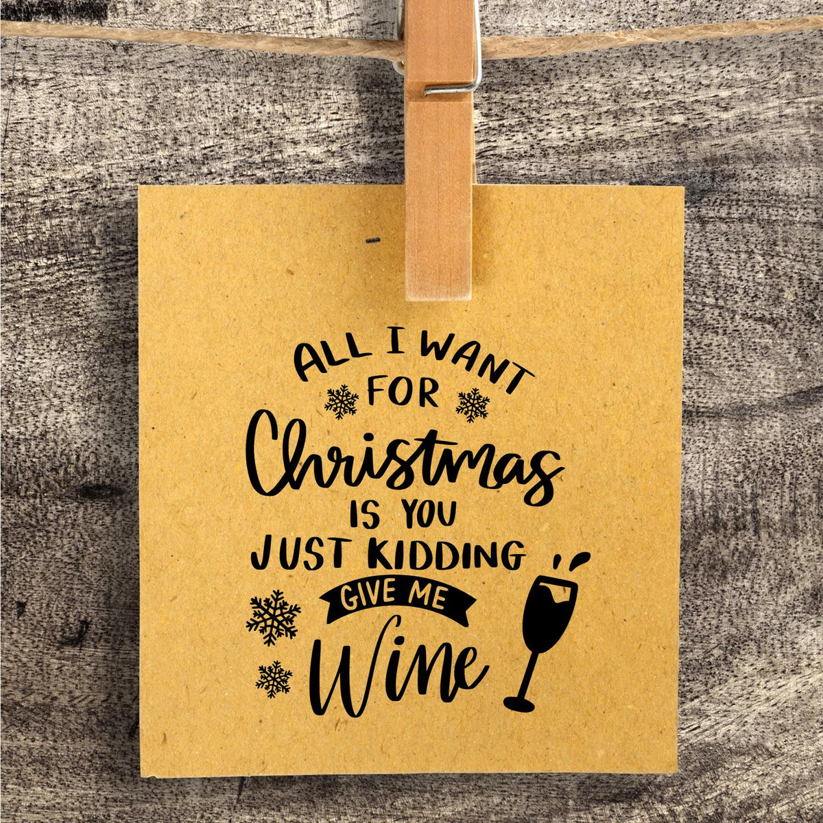 Christmas Just Give Wine Stamp - Premium Vintage Pro Wooden imprint stamped in black ink. "All I Want for Christmas Is You Just Kidding Give Me Wine" appears with snowflakes and a wineglass.