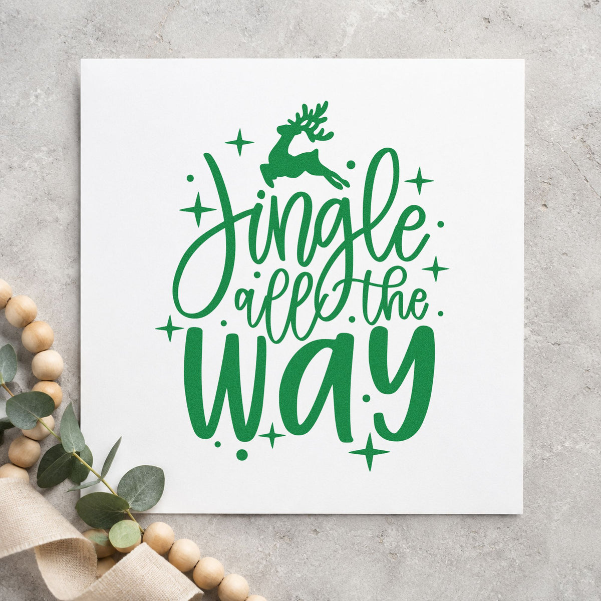 Jingle All The Way Reindeer craft stamp imprint in green ink on a handmade project, one idea being prize ribbon tags.