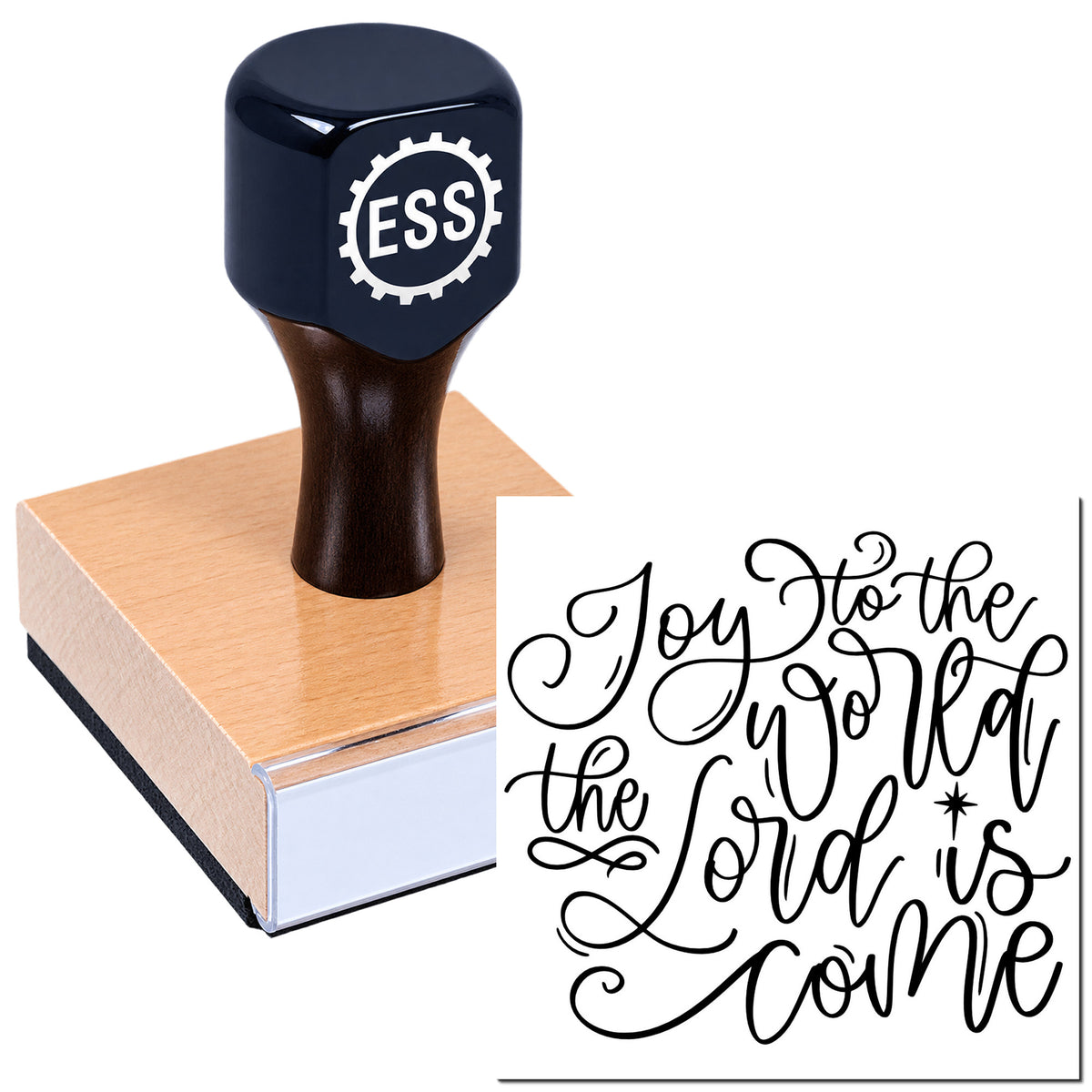 Dark navy ESS stamp with wooden handle beside a rose-gold seal block and black calligraphy "Joy to the world" design.
