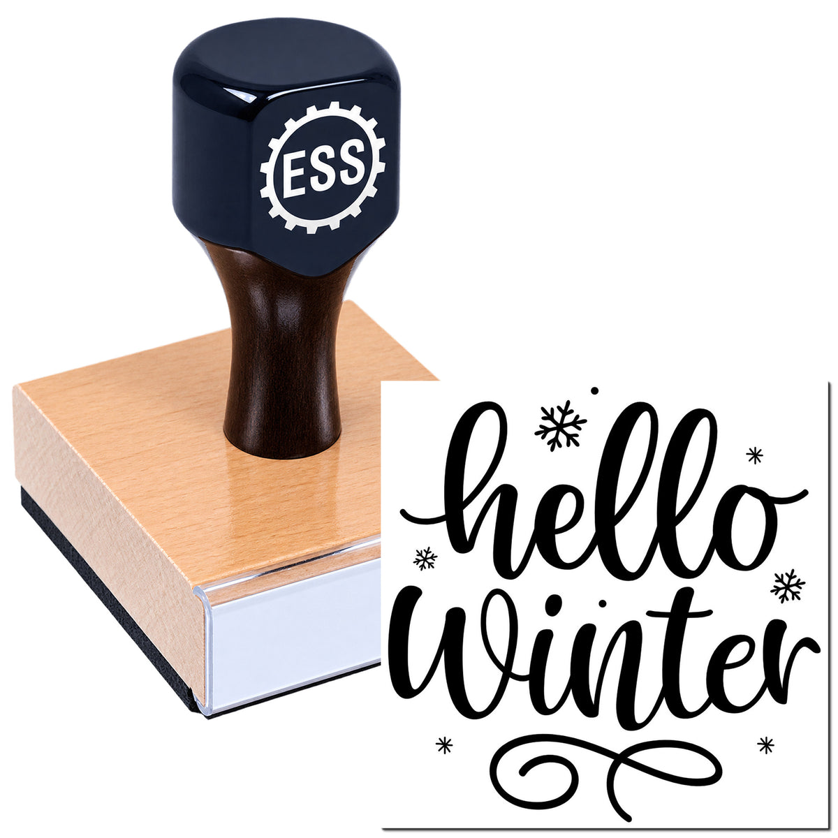 Dark navy rubber stamp and seal on wood block, stamping "hello winter" in black script with snowflakes.