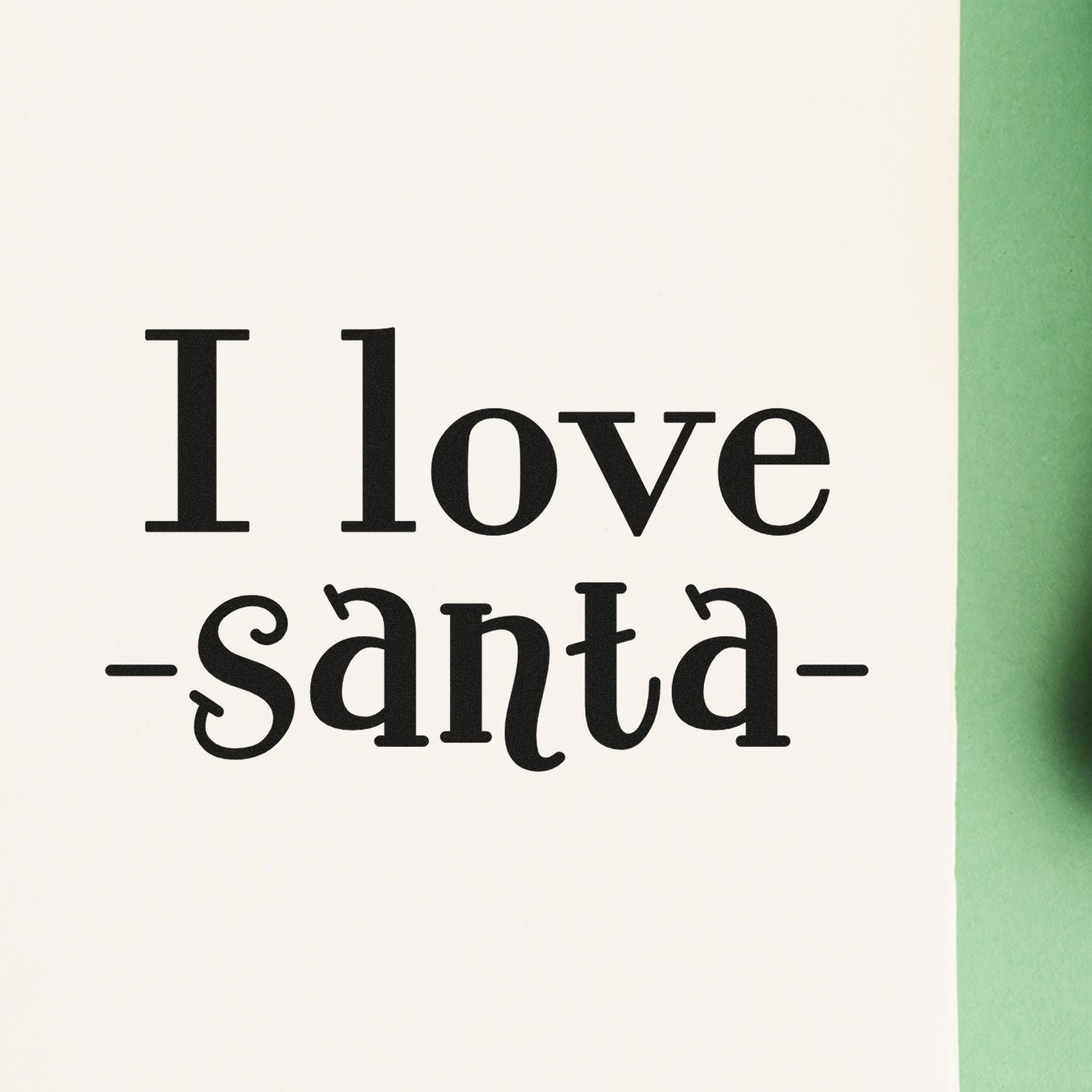 Black I love santa stamp on white cardstock with green edge, a holiday stamp and seal product.