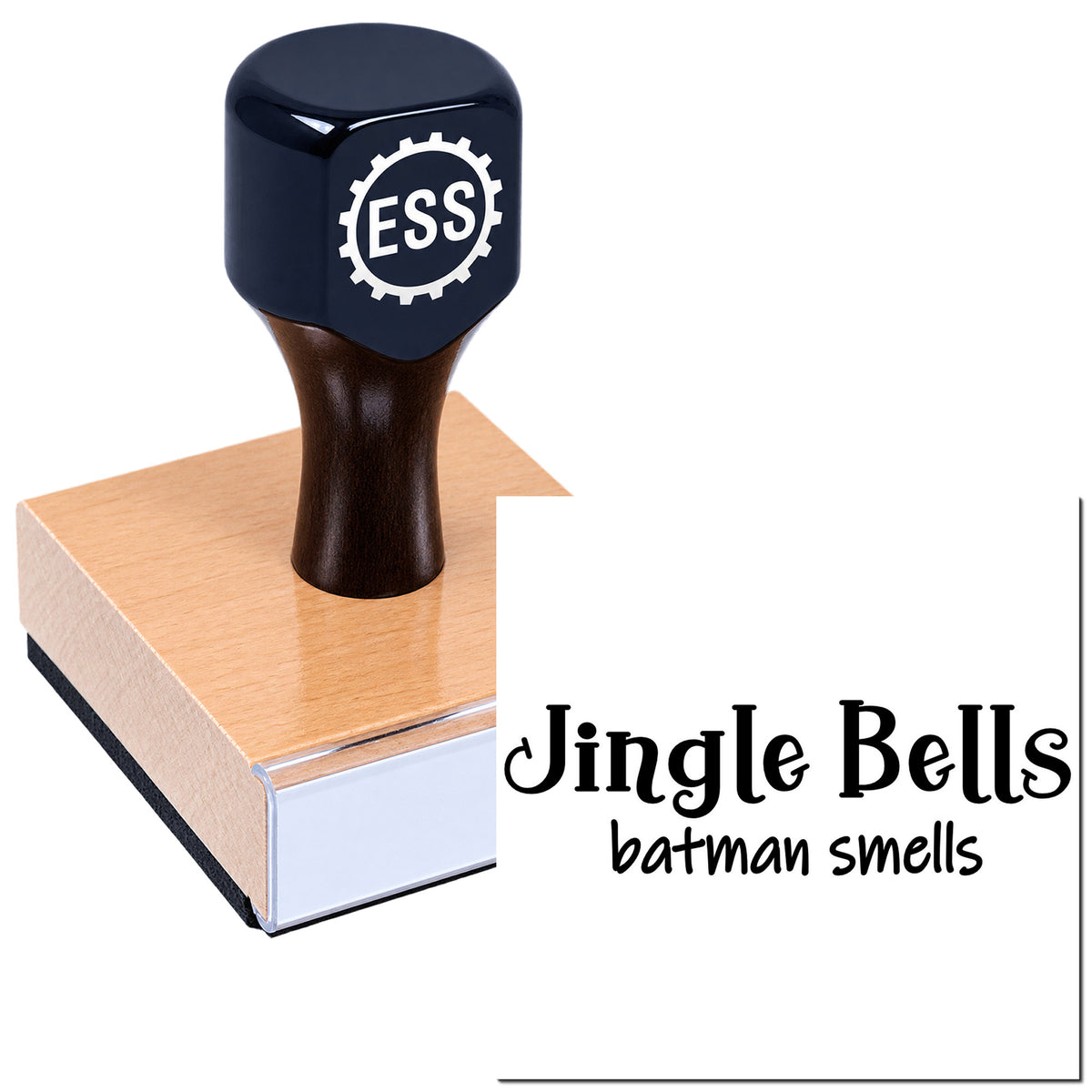 Black ESS rubber stamp on a wooden base with sample text "Jingle Bells batman smells" in black.