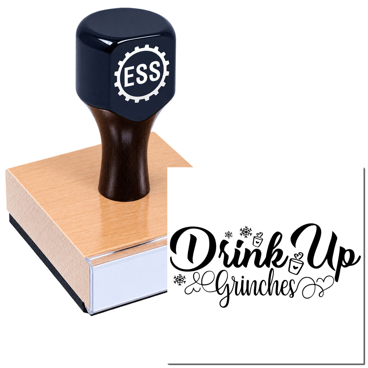 Dark navy stamp and seal on wood block with black "Drink Up Grinches" script and festive snowflake icons.