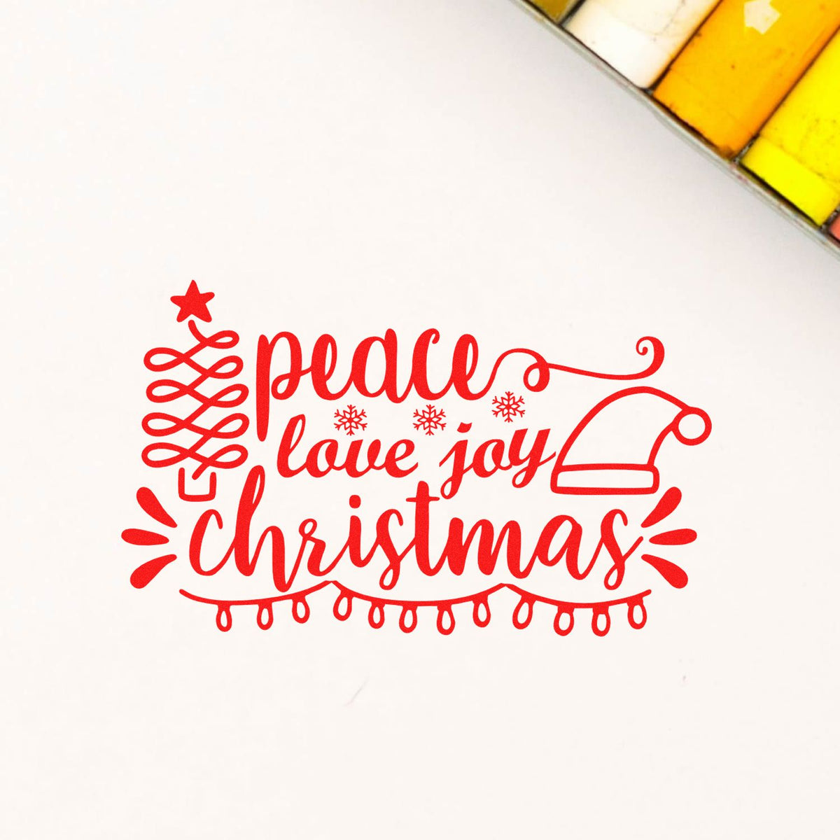 Red holiday stamp and seal design with peace love joy lettering, Santa hat, star, snowflakes, and string lights on white background.