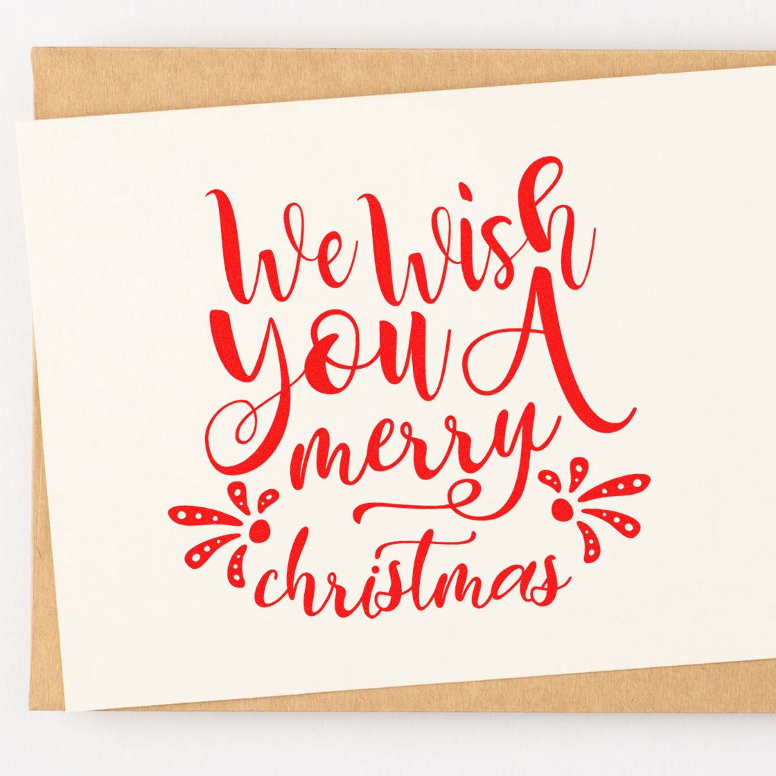 Red We wish you a Merry Christmas calligraphy stamp design on white card with kraft backing, festive seal