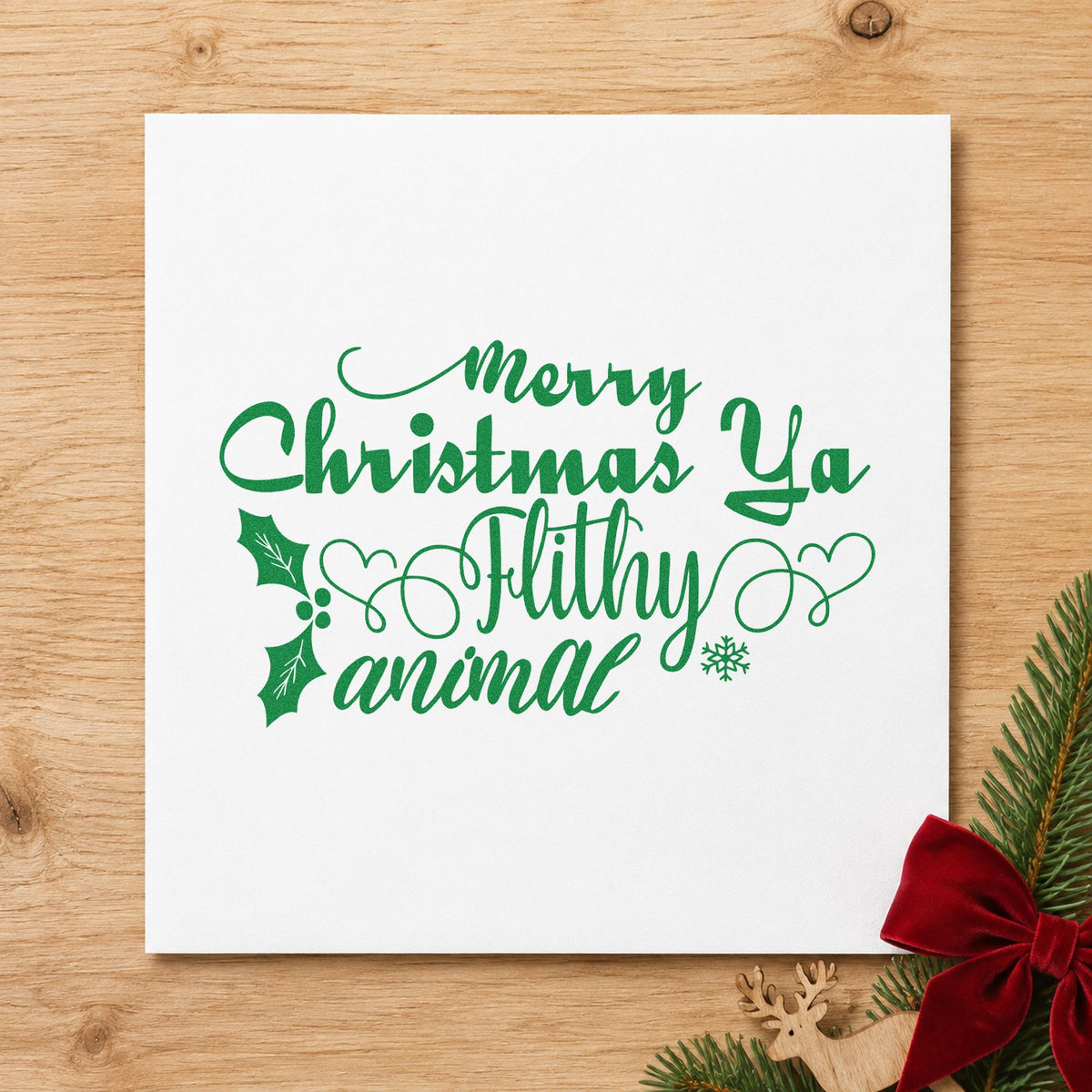 Merry Christmas Ya Filthy Animal craft stamp imprint in green ink on a handmade project, one idea being gag prize gift tags.